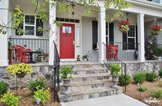 a red door sits on the front steps of a white house