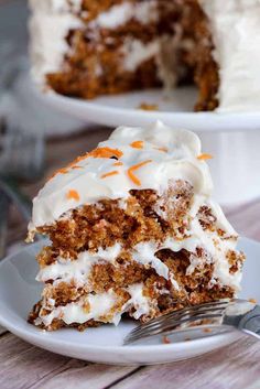 a slice of carrot cake on a plate with a fork