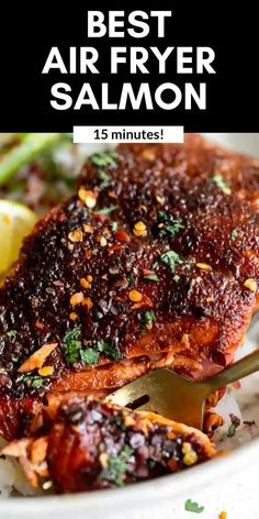 the best air fryer salmon recipe on a white plate with lemons and parsley