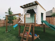 a backyard with a swing set and play house