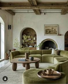 a living room filled with furniture and a fire place in the middle of the room