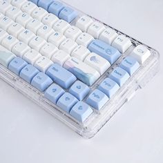 a blue and white computer keyboard sitting on top of a table