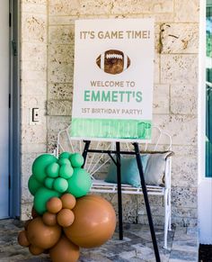 a welcome sign is displayed in front of a football themed birthday party entrance with balloons