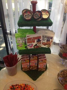 three tiered trays filled with food on top of a table next to a bowl of chips