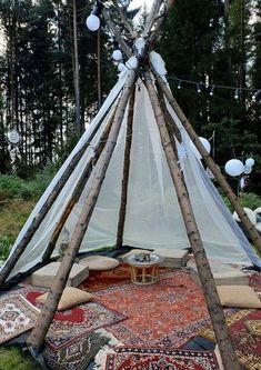 a teepee tent is set up in the woods