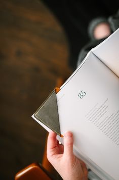 a person holding an open book in their hands