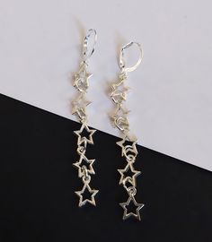 Long silver star dangling earrings with hypoallergenic and nickel free backs of your choice. Trendy Nickel-free Linear Drop Earrings, Trendy Silver Dangle Linear Earrings, Trendy Silver Star Charm Earrings, Trendy Silver Earrings With Star Charm, Trendy Silver Linear Earrings Gift, Trendy Silver Linear Earrings For Gifts, Hypoallergenic Sterling Silver Star Earrings, Hypoallergenic Sterling Silver Dangle Linear Earrings, Silver Adjustable Star Earrings