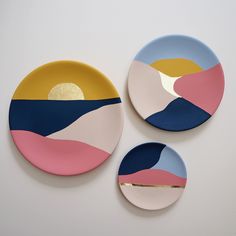 three plates with different shapes and colors on them