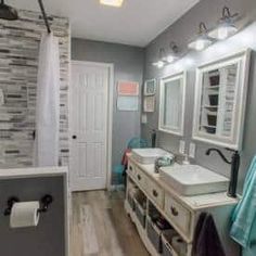 a bathroom with two sinks and mirrors in it