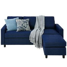 a blue couch with pillows and a blanket on it