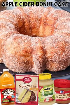 an apple cider donut cake on a plate with apples and other ingredients around it