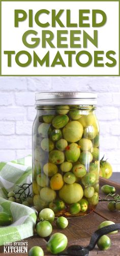 pickled green tomatoes in a mason jar with text overlay that reads pickled green tomatoes