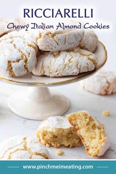 a white plate topped with cookies covered in powdered sugar next to another plate filled with baked goods