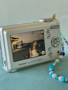 a camera with a necklace attached to it