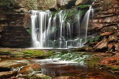 a waterfall with lots of water flowing over it