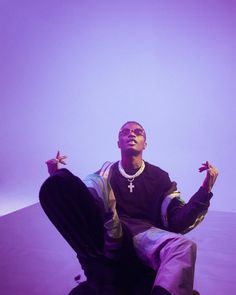 a man sitting on top of a purple floor