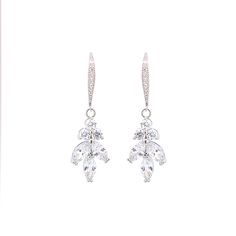 Made with petite round and marquis cut stones in a linear cluster, reminiscent of a leaf or vine with a French hook. Length: 1.5", Width: 1/2" 4.2 carat total weight Carat total weight based on diamond equivalent Custom gift box and microfiber storage pouch included Elegant Marquise Cut Cluster Earrings With Prong Setting, Elegant Marquise Cut Cluster Earrings, Formal Drop Cluster Earrings With Ear Wire, Elegant Marquise Cut Cluster Earrings For Formal Occasions, Elegant Marquise Crystal Earrings For Formal Occasions, Elegant Marquise Cut Cubic Zirconia Cluster Earrings, Dangle Diamond Earrings With Lever Back For Wedding, Custom Gift Boxes, Silver Drop Earrings