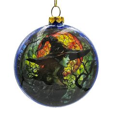 a glass ornament with a witch on it