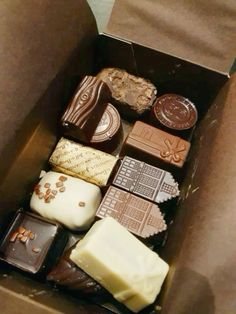 a box filled with lots of different types of chocolates