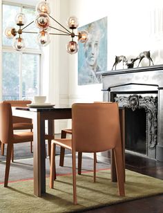 a dining room table with chairs and a fire place