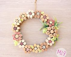 a wreath made out of wine corks and succulents