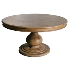 a round wooden table sitting on top of a white floor