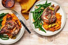 two white plates topped with meat and green beans