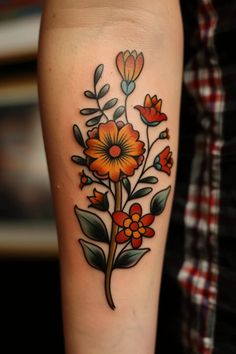 an orange flower tattoo on the arm