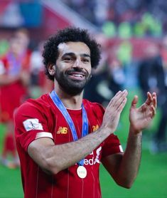 a soccer player is applauding with his hands in the air as he claps