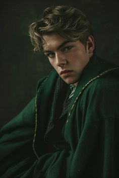 a young man wearing a green coat and tie