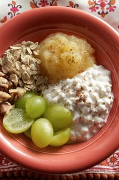 a red plate topped with fruit and nuts