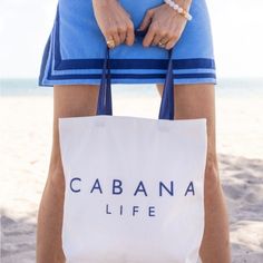 Brand New Cabana Life Tote Bag Classic Cabana Life Navy Logo On Canvas Tote Bag Perfect For Vacation Or A Day At The Beach! Brand New White Canvas Vacation Bags, White Bags For Daily Use In Beach Season, White Double Handle Bags For Beach Season, White Canvas Bag For Everyday Beach Use, White Bags For Beach Season, White Canvas Bag For Beach Season And Everyday Use, Blue Shoulder Bag For Everyday Beach Season, Blue Shoulder Bag For Everyday Use And Beach Season, White Bags Suitable For Beach Season