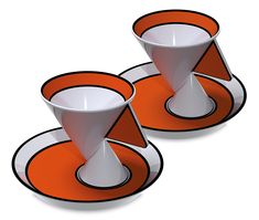 two orange and white plates with saucers on each plate, one in the shape of an upside down cone