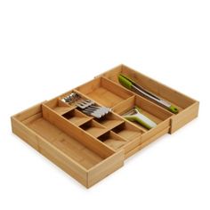 a bamboo tray with utensils and knives in it