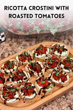 a wooden platter filled with mini pizzas on top of a counter