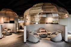 the interior of a restaurant with round tables and chairs