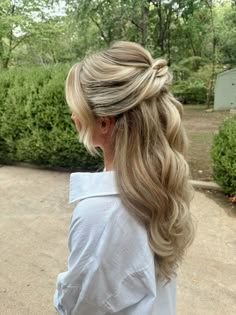 a woman with long blonde hair in a ponytail