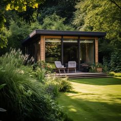 a small wooden cabin sitting on top of a lush green field