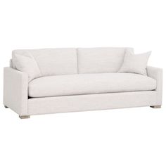 a white couch with two pillows on it