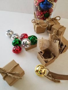 several different colored buttons are sitting on a table next to some brown boxes with bows