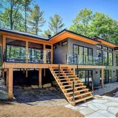 a large house with lots of windows and stairs leading up to the second story area