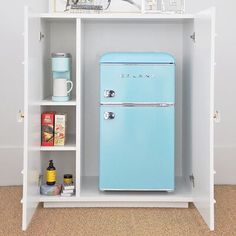 a blue refrigerator freezer sitting inside of a white shelf