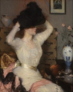 a painting of a woman in white dress and large black hat sitting on a bed