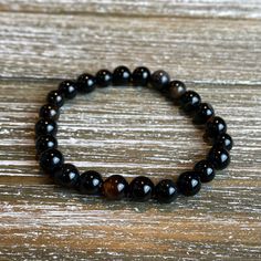 "Introducting the \"Blaze\" Collection! Beautiful individually or complete the look with a stack that makes a statement. vMix and match to find the look you love. Look stylish with an 8mm Natural Black Larvikite, 8mm Red Agate, 8mm Black Agate, and/or 8mm Smoky Quartz bead bracelet! Available accented with or without spacer beads and charms. (Please specify in the personalization section). Water proof and sturdy, yet shiny and chic! Held together with heavy duty stretchy bead cord. SIZING: Every Black Crystal Bracelet With Spacer Beads For Gift, Gift Black Crystal Bracelet With Spacer Beads, Black Stretch Bracelet With Spacer Beads As Gift, Black Beaded Bracelets With Spacer Beads As Gift, Black Healing Beaded Bracelets With Round Beads, Black Beaded Bracelet Gift, Handmade Black Beaded Round Bracelets, Black Beaded Bracelets With Polished Beads As A Gift, Black Charm Bracelet With 8mm Beads