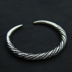 A massive bracelet made of sterling (925) silver. Bracelets, rings and other jewelry made in this style were very typical for the viking culture and could be found all around Europe of the early medieval period. The bracelet circumference (not including the gap between the ends) is 18.00cm (7.08 inch). It is 6.5mm (0.25 inch) thick. Viking Jewelry Mens Wrist, Viking Knit Jewelry, Mens Silver Jewelry, Knit Jewelry, Viking Knit, Historical Reenactment, Viking Bracelet, Bronze Necklace, Mens Bracelet Silver