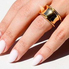 Add a touch of trendiness to your outfit with the Cylia Ring, a chunky and oversized gold ring that makes a statement on any occasion. The cylinder-shaped ring is crafted with 18K gold-plated materials, ensuring its durability and resistance to water. Geometric Design: The Cylia Ring features a unique cylinder shape, making it stand out as an eye-catching piece of geometric jewelry. Statement Piece: Its chunky size and oversized appearance ensures that it will always make an impact when worn. Suitable for all occasions or even daily wear; this trendy piece is sure to add some sparkle to your outfit - be it formal or informal! Trendy Wide Band Open Ring For Everyday, Chunky Ring, Bold Rings, Trendy Ring, Ring Fashion, Chunky Rings, Jewelry Statement, Cylinder Shape, Geometric Jewelry