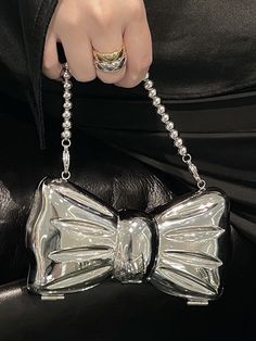 Get this mini bow-shaped evening bag for your fashion life. Quality materials ensure your all-day comfort. Bow-shaped design Beaded chains & metal chains High-quality metals Solid buckle closure Bag measures: L5.5” x W1.6” x H3.1” ( L14 x W4 x H8 cm ) Chic Metal Evening Bag For Party, Metal Evening Bag, Chic Party Evening Bag With Bow, Chic Bow Evening Bag For Party, Chic Silver Clutch For Gift, Trendy Silver Clutch Evening Bag, Chic Metal Bag For Party, Silver Chic Clutch For Gift, Chic Metal Party Bag