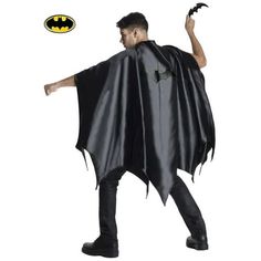 a man dressed in a batman cape and black pants with his hands out to the side