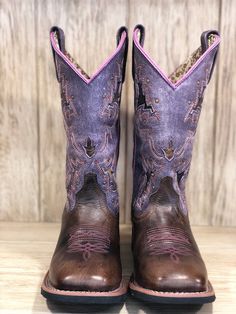 Get a great look, performance and comfort with the Lola Cowgirl Boots from Laredo. These boots have beautiful, two-tone leather construction with inlays, stitching and stud detailing. The comfortable insole and broad square toe design, plus Laredo's Cowboy Approved 2 outsole provides lasting comfort and traction. Whether you're in or out of the saddle, look and feel great in these gorgeous boots from Laredo. Tan leather vamp Purple leather shaft with inlays, studs and stitching 11" Shaft 1.5" St Square Toe Cowgirl Boots, Cowgirl Boots Square Toed, Square Toe Western Boots, Cowgirl Outfit, Inlay Design, Western Store, Toes Designs, Cowgirl Western, Cowboy Boots Women