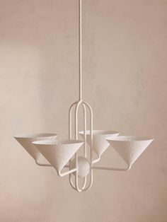 a white chandelier hanging from a ceiling with four bowls on it's sides